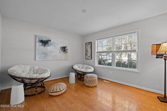 110 SE 7th St, Oak Island, NC 28465 - sitting room featuring wood finished floors and baseboards