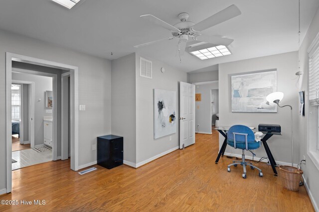 110 SE 7th St, Oak Island, NC 28465 - office area with ceiling fan, light wood finished floors, and baseboards