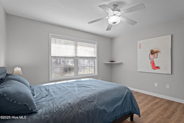 110 SE 7th St, Oak Island, NC 28465 - bedroom with wood finished floors, baseboards, and ceiling fan