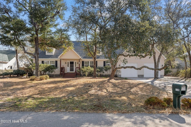 110 SE 7th St, Oak Island, NC 28465 - view of front of home with a garage, concrete driveway, and roof with shingles