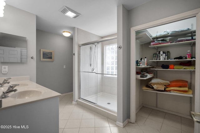 110 SE 7th St, Oak Island, NC 28465 - full bathroom with a stall shower, tile patterned floors, double vanity, and baseboards