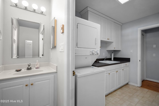 110 SE 7th St, Oak Island, NC 28465 - washroom with stacked washer / drying machine, baseboards, and cabinet space