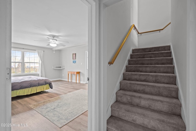 110 SE 7th St, Oak Island, NC 28465 - stairway featuring wood finished floors, a ceiling fan, and baseboards