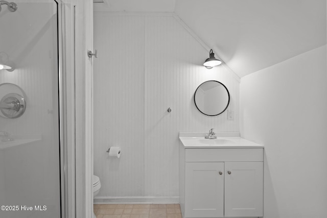 110 SE 7th St, Oak Island, NC 28465 - bathroom featuring lofted ceiling, a shower, vanity, toilet, and baseboards