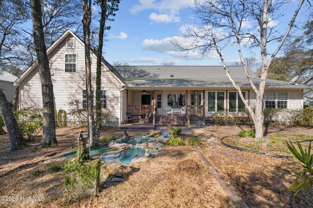 110 SE 7th St, Oak Island, NC 28465 - rear view of property with a ceiling fan and a porch
