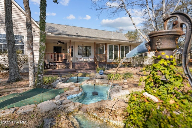 110 SE 7th St, Oak Island, NC 28465 - back of property with ceiling fan and a shingled roof