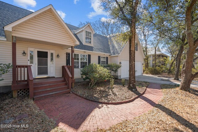 110 SE 7th St, Oak Island, NC 28465 - view of front facade with roof with shingles and concrete driveway