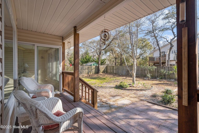 110 SE 7th St, Oak Island, NC 28465 - wooden terrace featuring a fenced backyard and a patio area