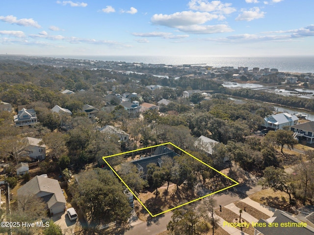 110 SE 7th St, Oak Island, NC 28465 - aerial view of residential area with property boundaries highlighted and a large body of water