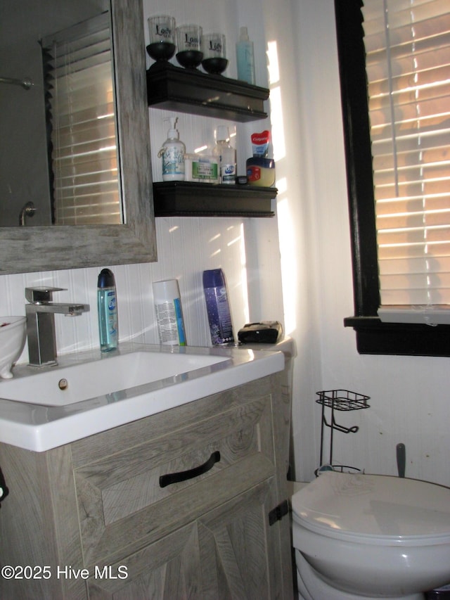 half bathroom with toilet and vanity