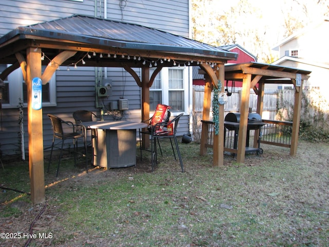 exterior space featuring fence and a gazebo