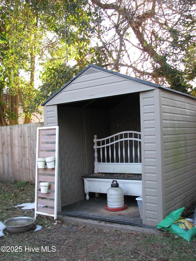 view of shed featuring fence