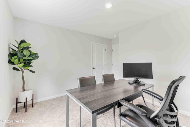 office featuring baseboards and light colored carpet