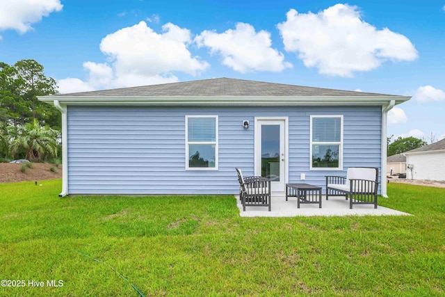 rear view of property with a patio and a lawn