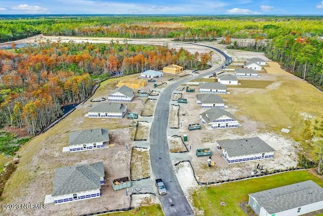 drone / aerial view featuring a forest view