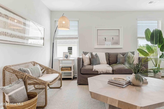 carpeted living area featuring visible vents