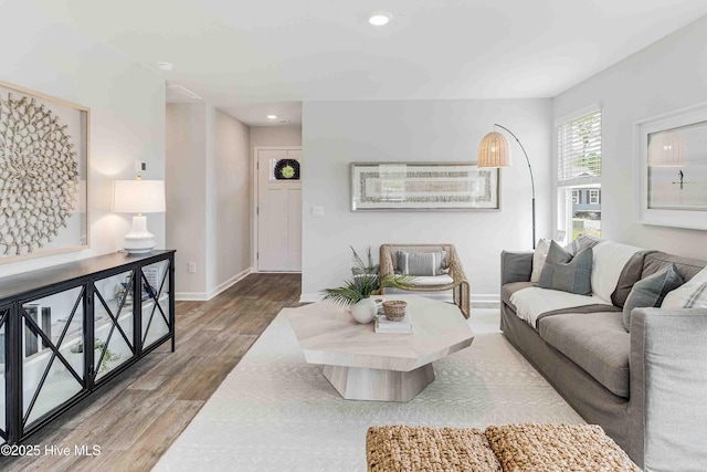 living area with recessed lighting, baseboards, and wood finished floors