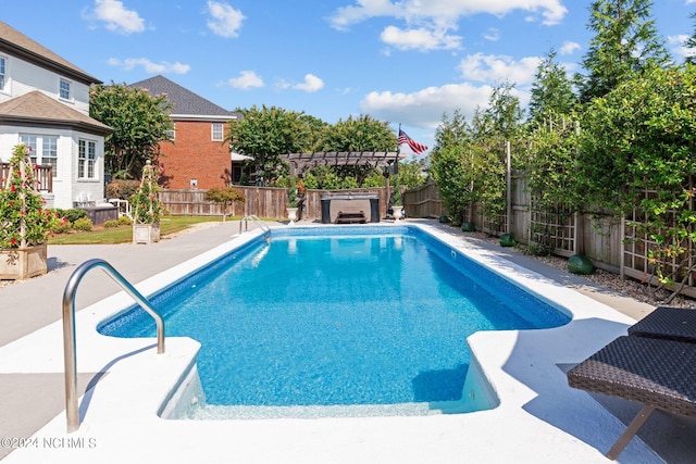 view of swimming pool featuring a patio area, a fenced backyard, a fenced in pool, and a pergola