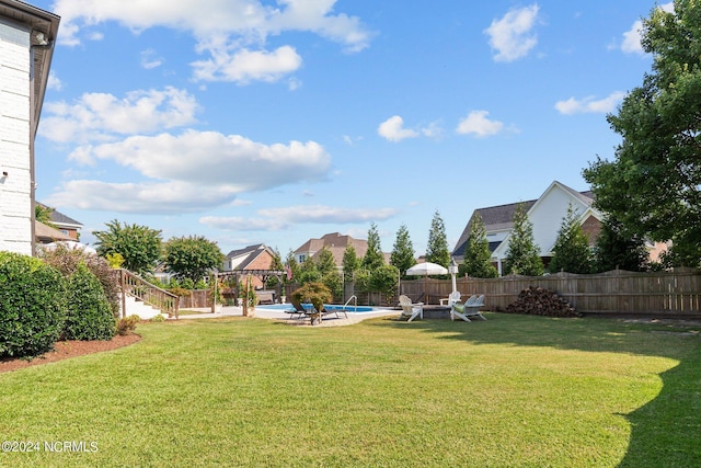 view of yard with a patio, fence, and a fenced in pool