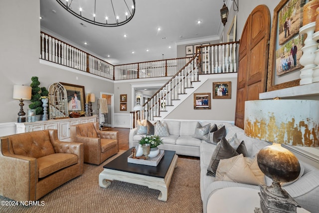 living room with stairs, a high ceiling, recessed lighting, and crown molding