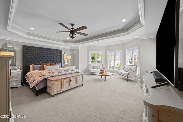 carpeted bedroom with a tray ceiling, crown molding, and recessed lighting