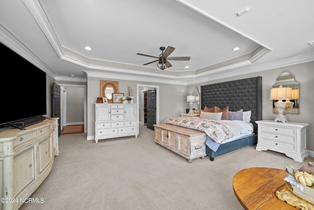 bedroom with a tray ceiling, recessed lighting, light colored carpet, ornamental molding, and baseboards