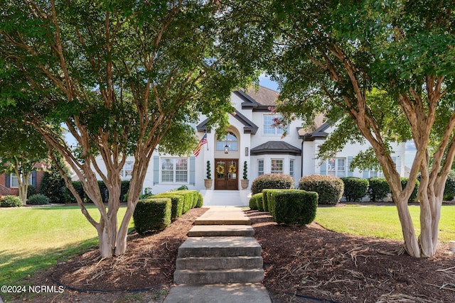 view of front of home with french doors and a front yard