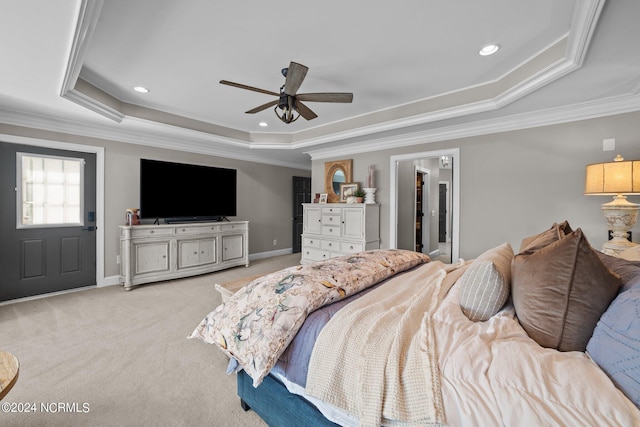 bedroom featuring light carpet, a tray ceiling, recessed lighting, and crown molding