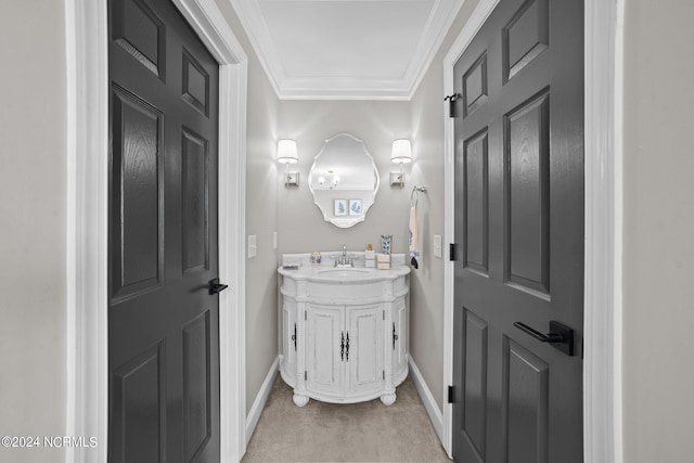 bathroom with ornamental molding, vanity, and baseboards