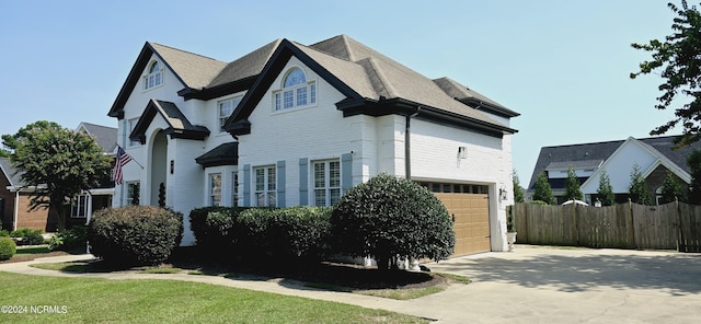 view of side of property with driveway and fence