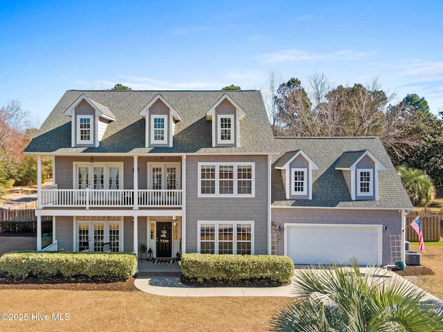 view of front of home with french doors, roof with shingles, a porch, and a balcony