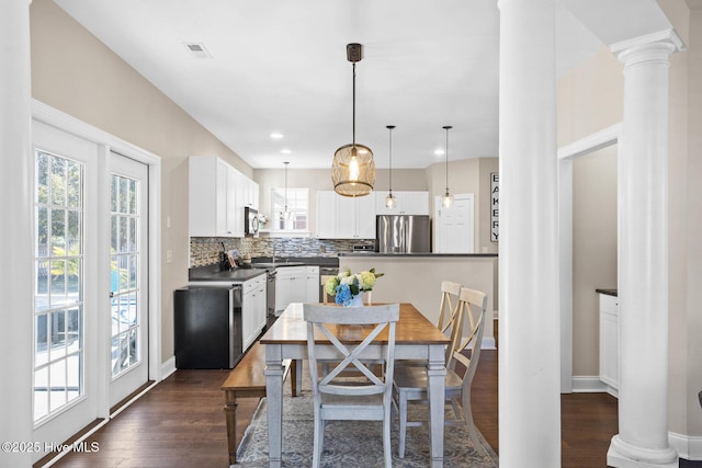 dining area featuring visible vents, baseboards, dark wood-style floors, ornate columns, and recessed lighting