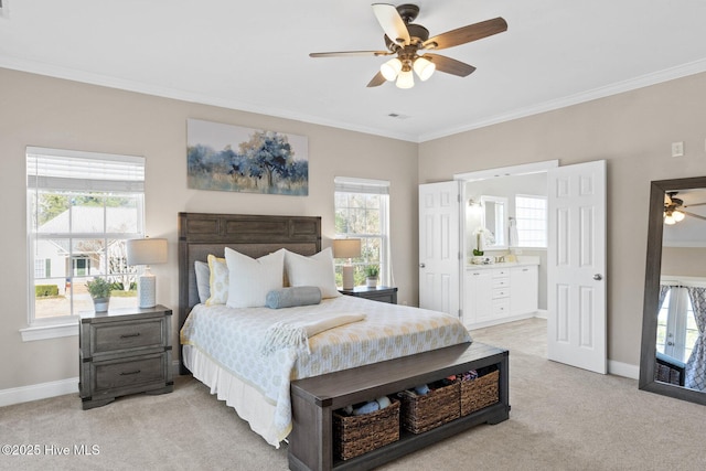 bedroom featuring connected bathroom, light colored carpet, a ceiling fan, baseboards, and ornamental molding