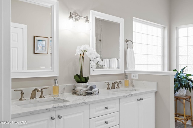 full bath with double vanity and a sink