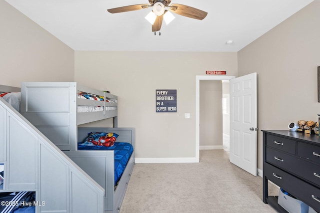 bedroom featuring light carpet, ceiling fan, and baseboards