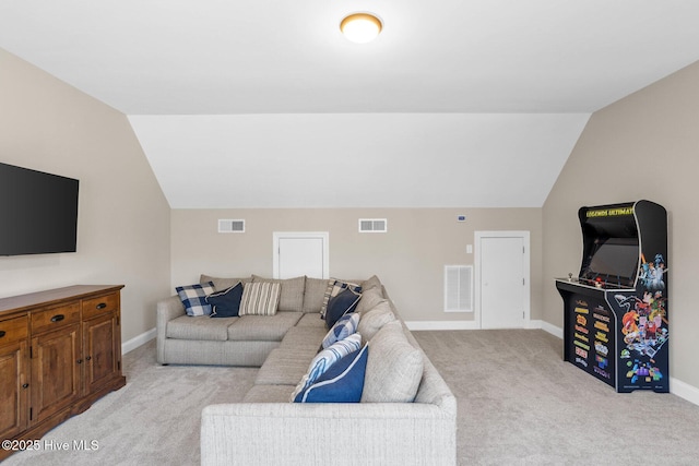 living area with light carpet, vaulted ceiling, and visible vents