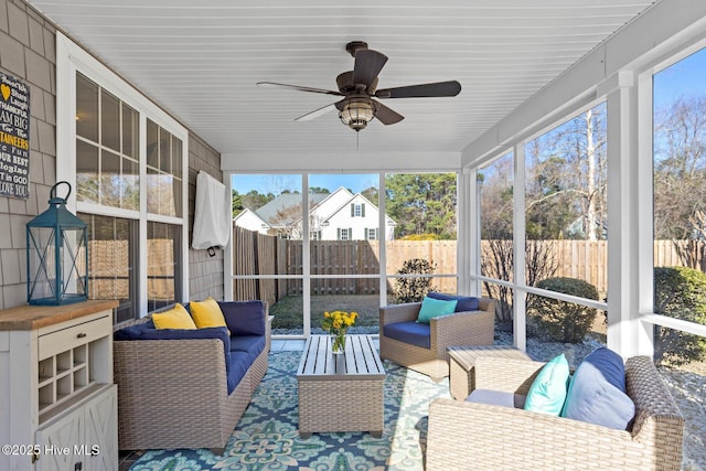 sunroom / solarium featuring a ceiling fan