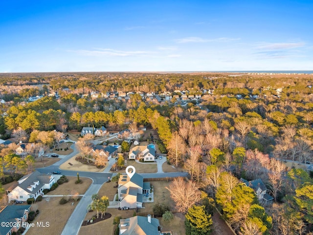 birds eye view of property with a forest view