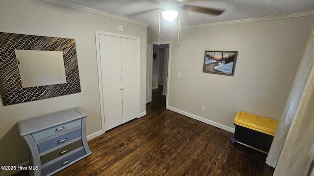 bedroom featuring crown molding, wood finished floors, baseboards, and ceiling fan