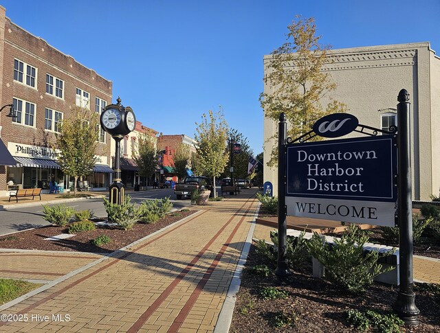 exterior space with curbs, street lights, and sidewalks