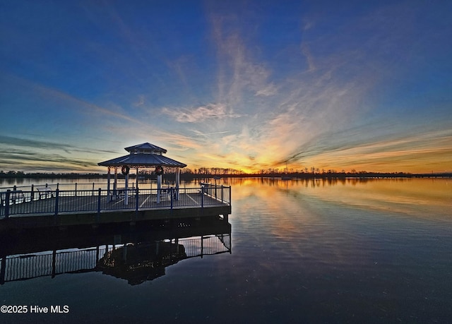 view of dock with a gazebo and a water view