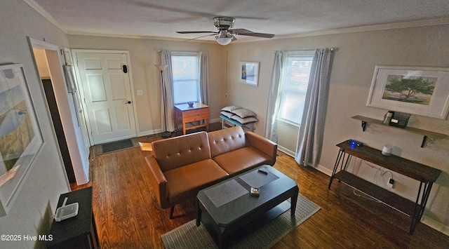 living area featuring a healthy amount of sunlight, wood finished floors, and crown molding