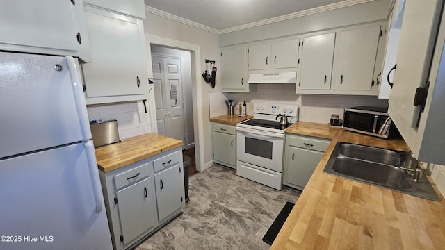 kitchen with white appliances, wooden counters, a sink, ornamental molding, and under cabinet range hood