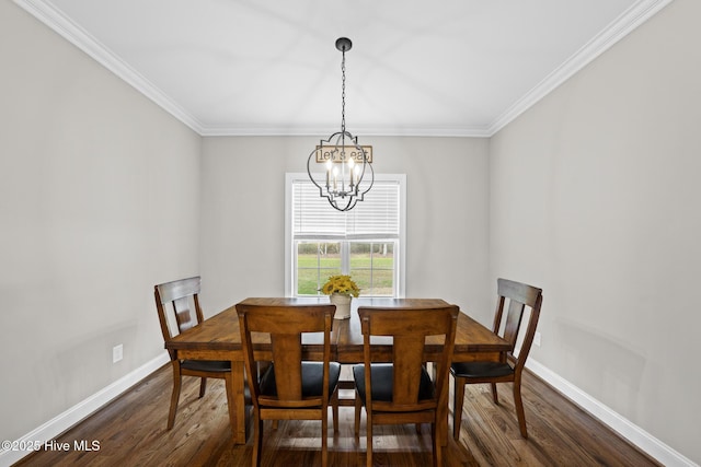 dining area with a chandelier, dark wood-type flooring, crown molding, and baseboards