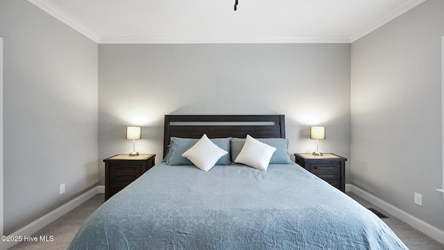 bedroom with carpet floors, baseboards, and crown molding