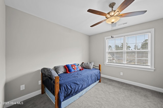 bedroom with carpet flooring, visible vents, ceiling fan, and baseboards