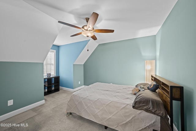 carpeted bedroom with lofted ceiling, ceiling fan, and baseboards