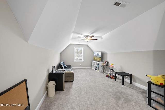 interior space with lofted ceiling, baseboards, visible vents, and carpet flooring