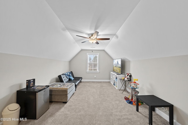 living area with lofted ceiling, ceiling fan, carpet, and baseboards