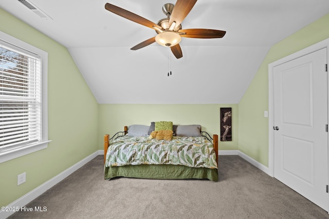 carpeted bedroom featuring lofted ceiling, ceiling fan, visible vents, and baseboards